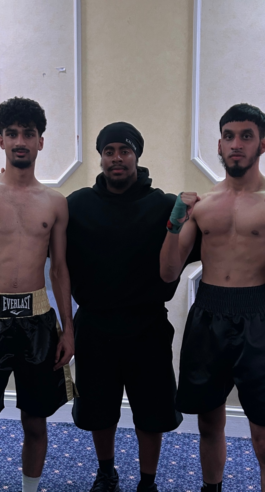 Coach Leonardo with two boxers before a bout