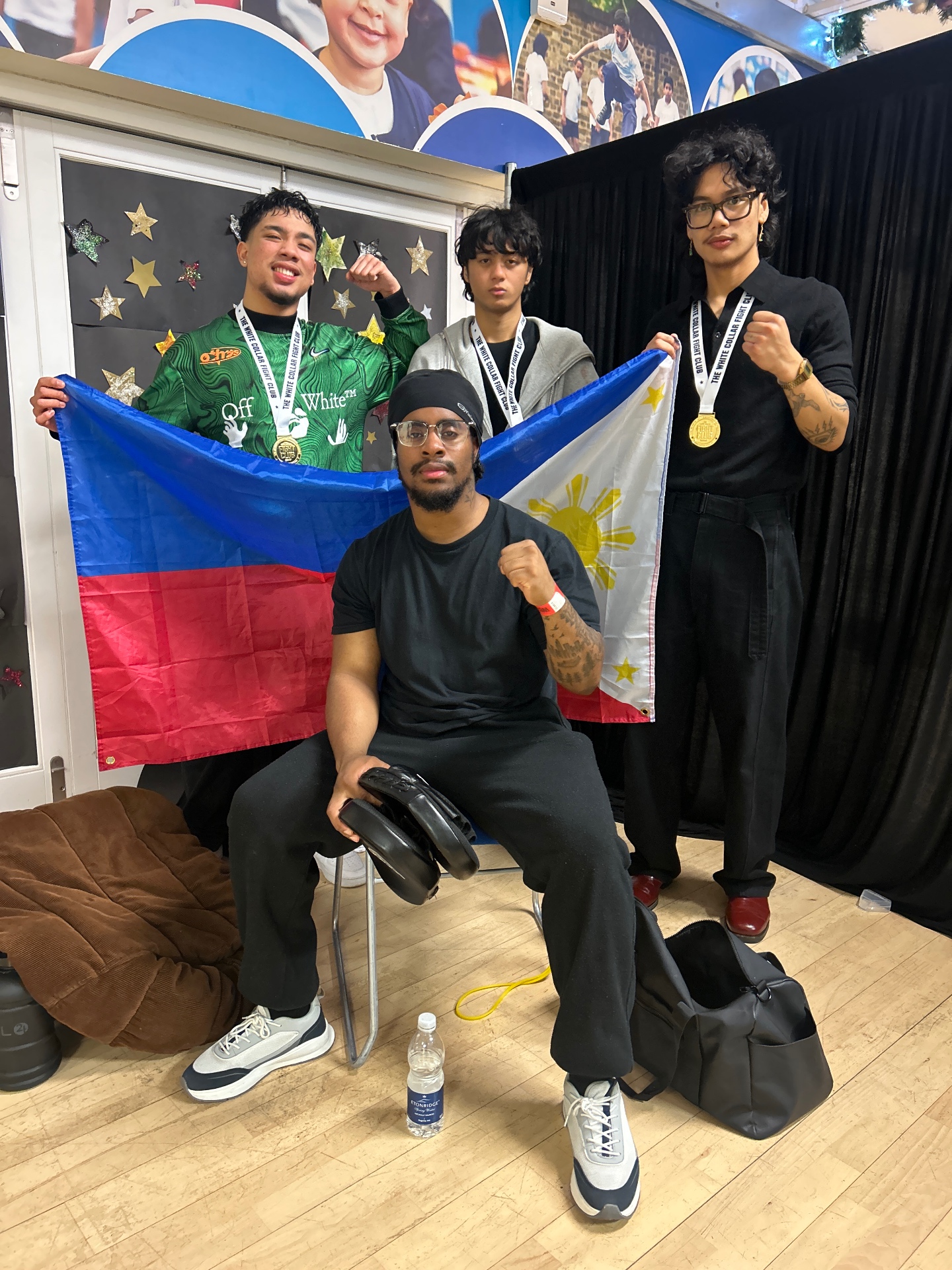 Fighters with medals after a white collar fight night